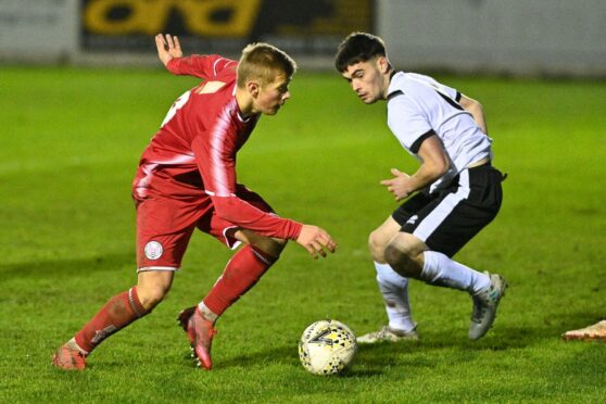 Brechin City midfielder Max Kucheriavyi goes up against Shaun Sutherland of Clach