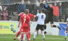 Clach goalkeeper Martin MacKinnon deals with a corner