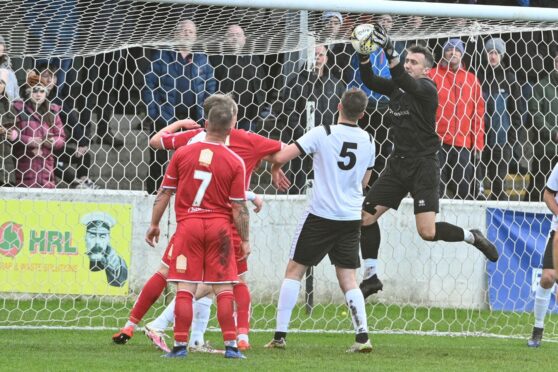 Clach goalkeeper Martin MacKinnon deals with a corner