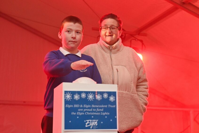 Daniel Little, 11, switches on the Christmas Lights with mum Tricia Little. Pictures by JASON HEDGES