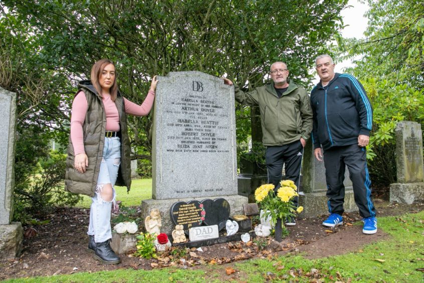 Stephanie and her uncles at David's grave.