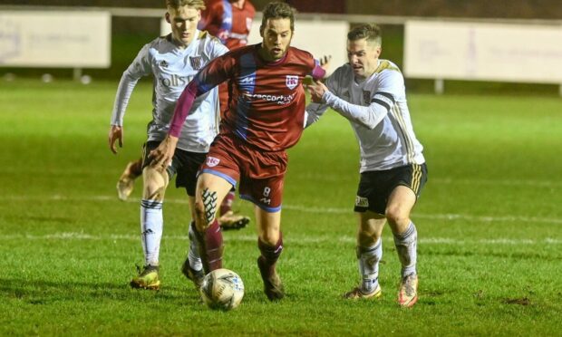 Keith's James Brownie, centre, tries to hold off Formartine's Graeme Rodger, right, and Cole Anderson