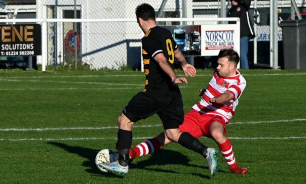 Picture of Stonehaven's Keith Horne being tackled by Stoneywood Parkvale's Liam Bain. Image: Kenny Elrick