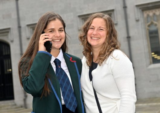 Lily Macdonald celebrates with her mum Emma Davidson after recieving a call to tell her she been accepted into university.