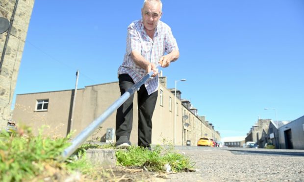 Councillor Brian Topping weeding in Fraserburgh.