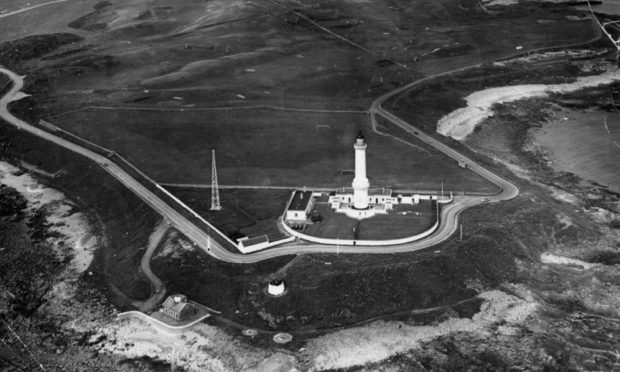 A scenic view of Kinnaird Head Lighthouse in Fraserburgh in 1978, built through Kinnaird Head castle with the castle wine tower in the foreground.