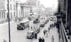 1958: Bikes, buses, cars and vans and even a horse and cart pass the Music Hall