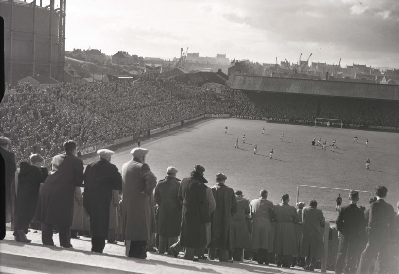 1957: Crowds watch on at a match at Pittodrie Park, Aberdee, the home of Aberdeen FC.
