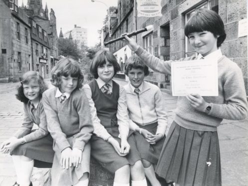 1981: Proud moment for Stonehaven girl Ann Cairnduff as she holds up her certificate after winning the under 10 solo descant recorder section yesterday. Looking on are schoolfriends who also competed (left to right) Sandra Lonie, Nicky Fraser, Jennifer Crabb and Fiona Ingram (all Stonehaven).