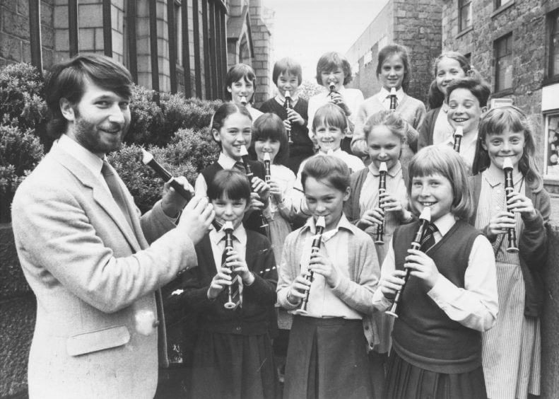 1986: Youngsters from Tarves, Udny Green and Aberdeen's St Margaret's School gather outside the Kirk House in Aberdeen during the music festival yesterday. Competitors in the descant solo contest for under nines, they were judged by Colin Touchin (extreme left).