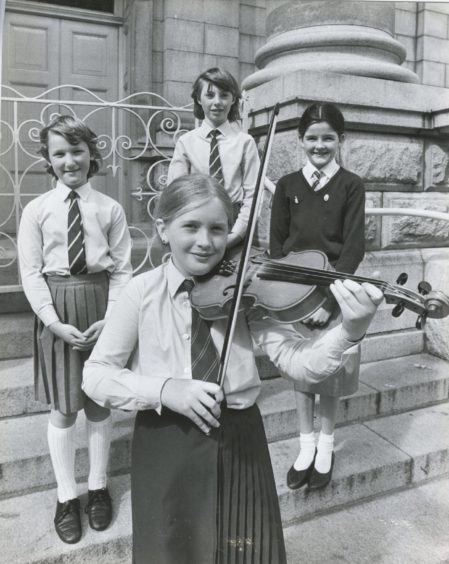 1986: Winner of the violin (10 and under) section in the Aberdeen and North East of Scotland Music Festival, Katie Sarah Jones, Ellon Primary, strikes a winning pose with runners up, from left, Louise Cumming and Angela Bell, both Auchterellon, who were second equal and third placed Linnea Nicol, Hazlehead.