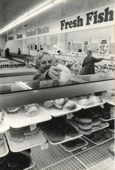 1983 - A shopper picks up something to eat from a reorganised Norco now boasting more fresh food units than previously