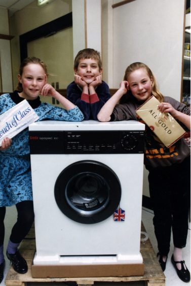 1991 - Timothy Anderson, 8, did not win a bike but he did win a washing machine. His prize was appreciated by his mum, Christina, and dad, Jim. He is pictured with 10-yearold twin sisters Lois, left, and Esther