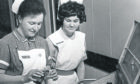 Staff Nurse I. R. Dufour, from Switzerland, does the rounds with nurse M. J. Campbell