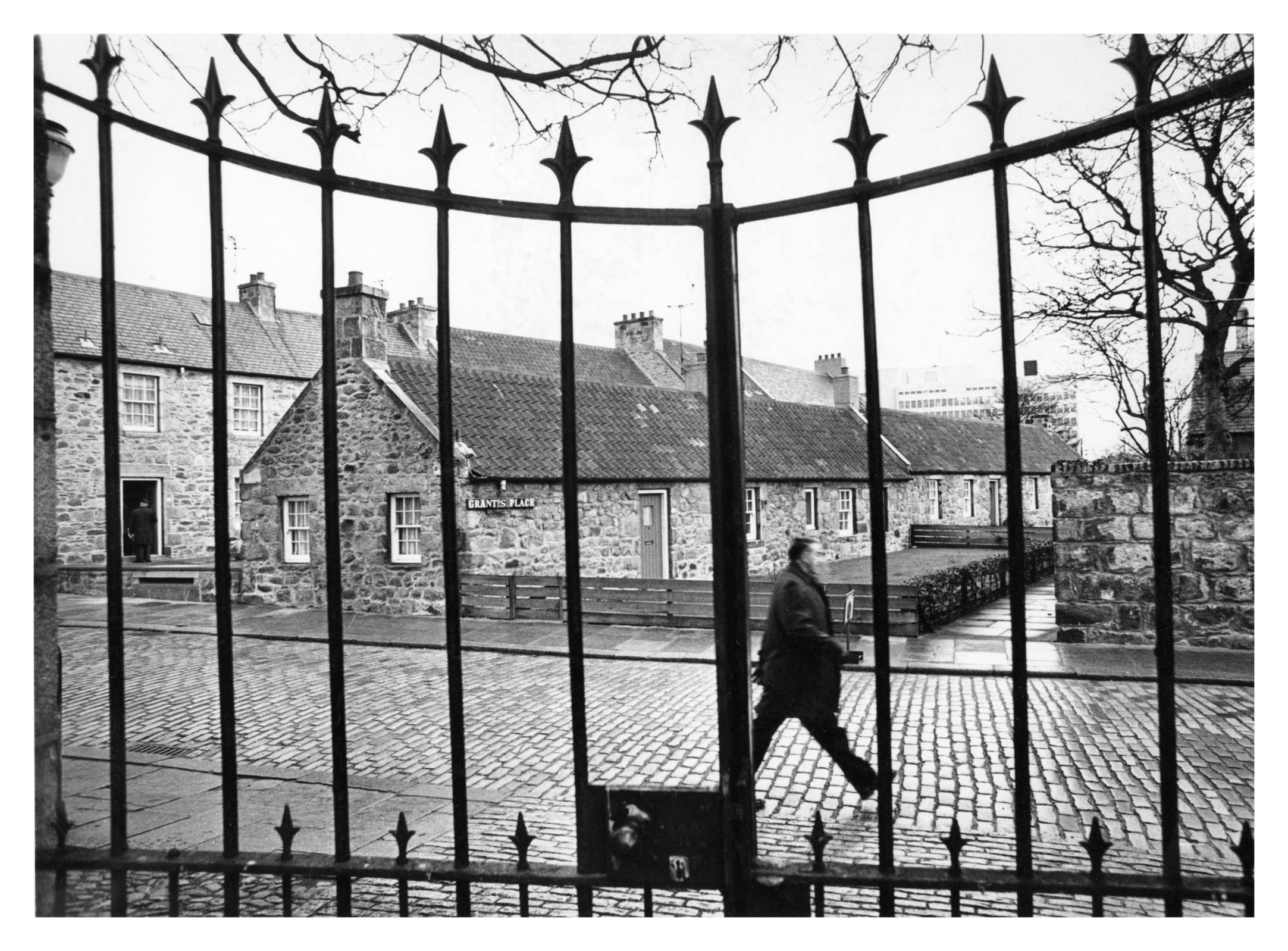 1971: A pedestrian on cobbled Grant's place and the High Street in Old Aberdeen.