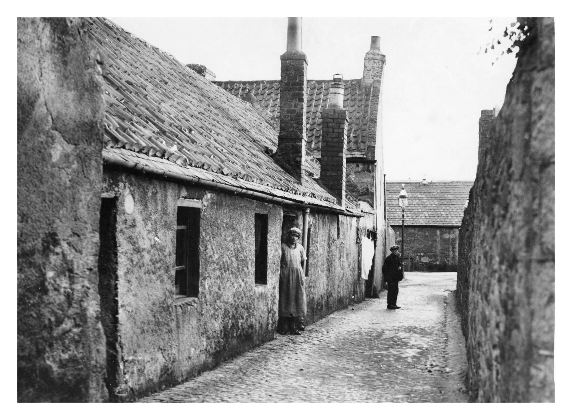 1930s Local folk keep an eye on the photographer in this image of Clark's Lane.