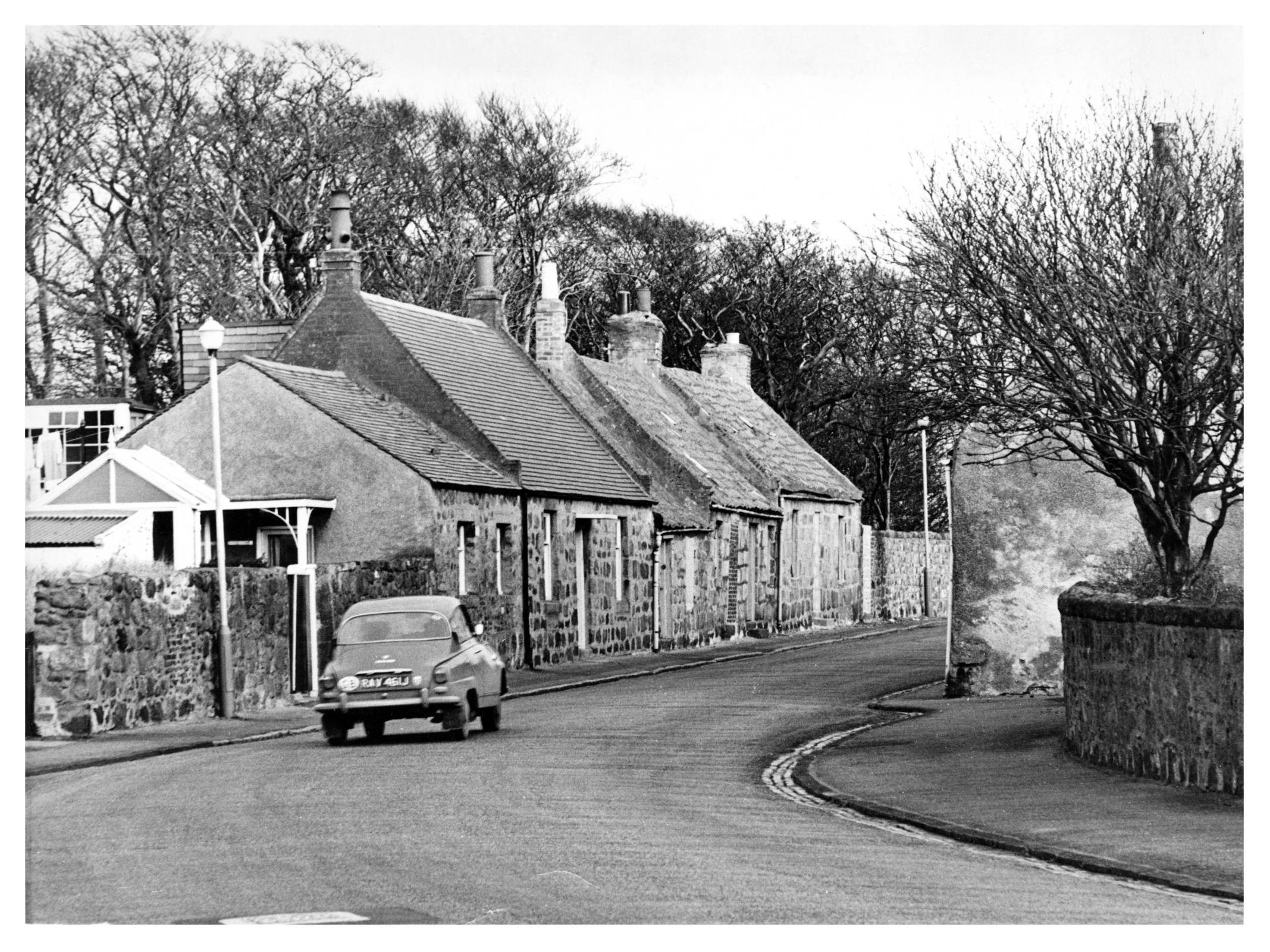 1971: Numbers 115, 117 and 119 Dons Street - rubble-built, pan tiled cottages - were scheduled for preservation.