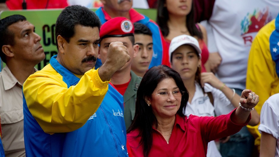 Venezuelan president Nicolas Maduro and first lady Cilia Flores greet supporters in Caracas (AP)