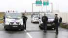 Police officers monitor the situation during a blockade on the roads around the port of Calais