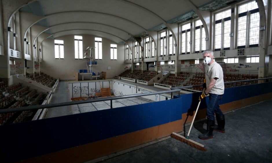 New Bon Accord Heritage chairman Bruce Strachan, pictured in August 2020, cleans up debris left by the elements and vandals at Bon Accord Baths.