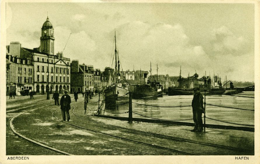 20th century portrait of workers from a fishcurers on Torry’s Sinclair Road. The fishing industry created many jobs onshore especially following the boom of the 1880s. Fishcurers would gut and preserve fish for local and export markets. This could involve smoking, pickling, salting or air-drying fish.
