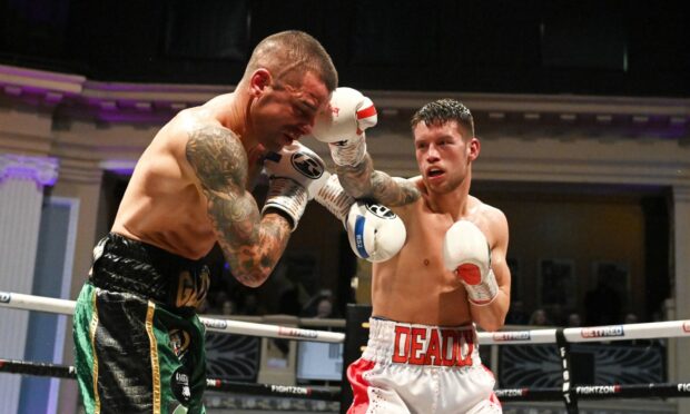 Aberdeen's Dean Sutherland (in red ) lands a punch against Michele Esposito in the WBC International Silver title fight.