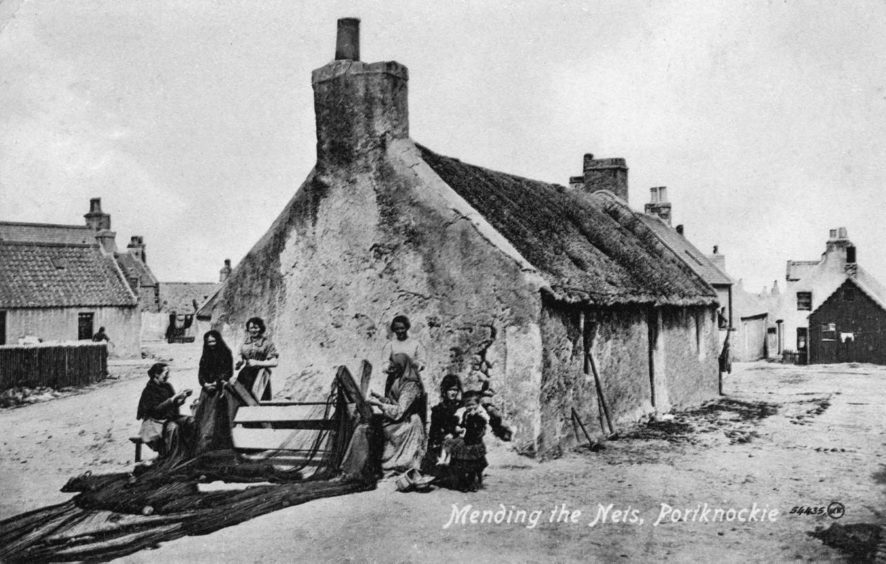 Workers mending the nets.