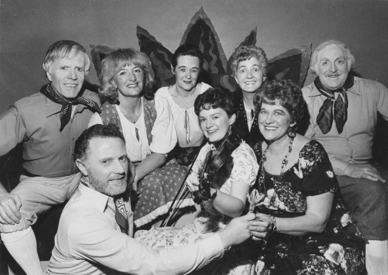 1985: Performers from The Best of Both Worlds, which is being staged at Aberdeen College of Commerce by Pro Arte this week, take the stage for a souvenir picture. Serenading the Gipsy Princess (Margaret Robertson, Aberdeen) and the Gipsy Baron (Ian Middler, Aberdeen) is Tricia Shand, Buckle, while looking on (left to right) are Norman McDonald, Frances Wregg, Sheena Hunter, Betty Davie and Eric Coutts, all Aberdeen.