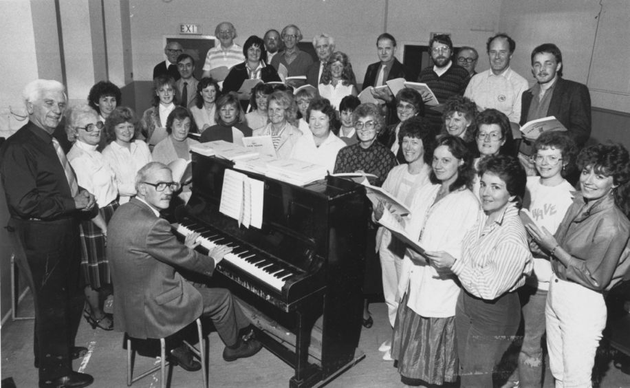 1987: ready for their forthcoming winter of rehearsals for The New Moon by Sigmund Romberg are members of Pro Arte with pianist Mr Leslie Bodie, their new associate musical director Mr Locke Nicholson (left) and musical director Mrs Kathleen Stuart (second left). 
The company have grown to about 50 members in recent years. We realised that another person was required to concentrate on the musical direction of principal parts, said chairman Mr Bill Stuart.
We are very pleased to secure the services of Locke Nicholson. Mr Nicholson is the former principal teacher of music at Summerhill Academy and is well known in North-East music circles. He is a trustee of the International Youth Festival and is chairman of Deeside Choristers.
