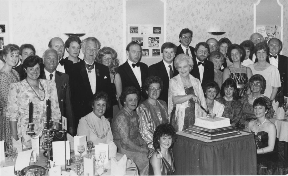 1988: Members of the Light Opera Company Pro Arte cut their Birthday cake to celebrate 20 years of Musical Entertainment. Past and present members joined in a dinner and dance in the Amatola Hotel, Aberdeen on Saturday evening. The company has performed many well known shows over the years, including Merry Widow, Waltzes from Vienna and his year's showt he New Moon pictured cutting the cake is Musical Director Mrs Kathleen Stuart.