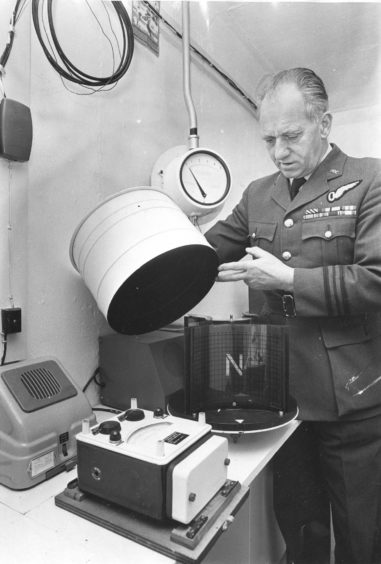 1975 - Lt. Commander Johnston checks the apparatus used to check a bomb’s position