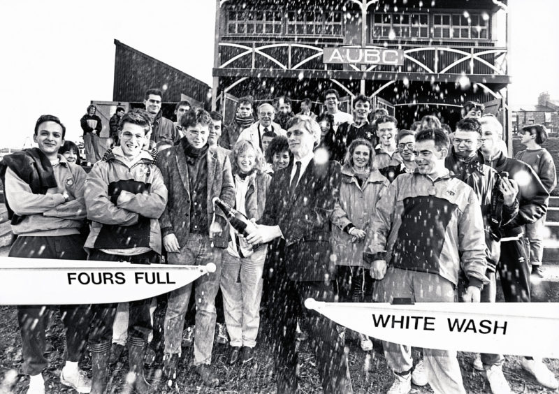 1989: Splashing in with £10,000 sponsorship Sysdrill managing director Dave Raby performs the champagne naming of the two new Aberdeen University Boat Club boats Fours Full and White Wash watched by Club captain Paul Nymah and members.