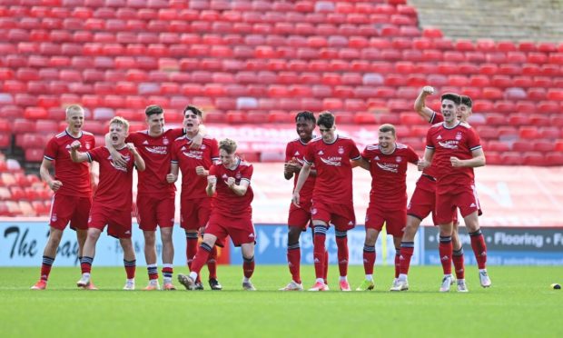 The Aberdeen players celebrate their penalty shootout win against Arbroath.