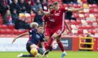 Aberdeen's Ryan Hedges,right, tackles Ross Stewart during the Ladbrokes Premiership match between Aberdeen and Ross County at Pittodrie Stadium