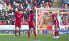 Aberdeen's Scott McKenna, Greig Leigh and Andy Considine (L-R) exchange words during the Ladbrokes Premiership match between Aberdeen and Celtic.