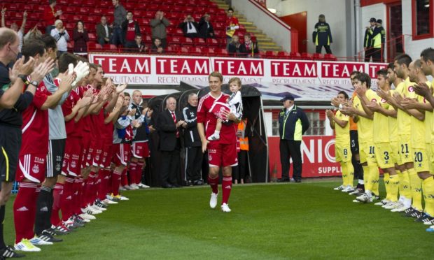 Aberdeen's Darren Mackie receives a   warm welcome from the crowd in his testimonial.