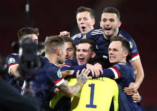 Scotland's players celebrate victory in the penalty shoot-out.
