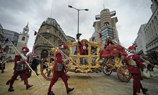 Vincent Keaveny, the 693rd Lord Mayor of the City of London, waves from the State Coach during the Lord Mayor's Show in the City of London. Photo: Aaron Chown/PA Wire