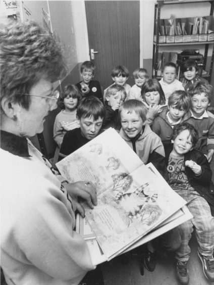 1987 - It's story time (above) as librarian Moira Keay entertains a happy group of local youngsters enjoying themselves during the weekend's Seaton Community Festival.
