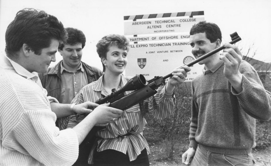 Shell 1988-04-25 Karen Falconer (C)AJL

25 April 1988

"Shooting Stars...Getting to grips with an air rifle at the Superstars competition held in aid of the Give a Child a Chance Appeal is Karen Falconer, aided by, from left, Evander McRae, Colin Paterson and Adrian Austin. Taking part in the competition, which runs until Thursday, are 150 trainees and 30 staff at the Shell Training Centre, Altens. There are 12 events, including swimming, running and shooting."

Used: P&J 26/04/1988