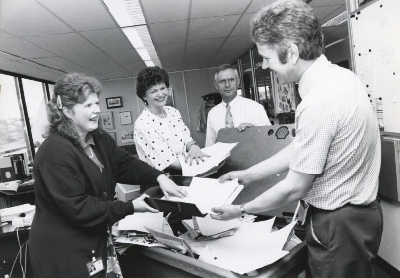 Shell 1991-05-31 Gordon Wood (C)AJL

31 May 1991

"Green Man: Gordon Wood (right), collects office papers for recycling in the community relations office, at Shell's Altens headquarters, from community relations officer Judith Munro (left), and visits and events officer Margaretha Simpson. Looking on is Johan Kwant."

Used: EE 18/06/1991