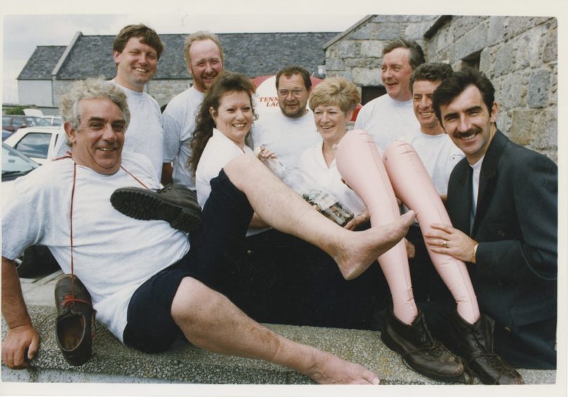 1993: Twenty Shell and oil service company employees have reached charity peaks by forming an over the hill walking group for the over 40s. Donnie Wright of Weatherfold service company, and friends completed a 30 mile walk - the Lairig an Loaigh - from Braemar to Nethy Bridge and have raised £5,000 for local children's charities. At a gathering of representatives in the Mains of Scotstown, Aberdeen, they invited Dons player Bobby Connor to receive part of the proceeds for Aberdeen FC players' Handicapped Children's Holiday Fund. Staff members Moira Longstaff and Kath Stewart handed over the donation.