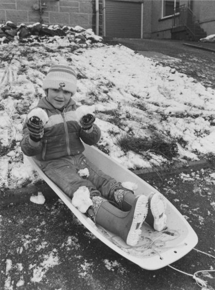 1982: The first fall of snow of the winter certainly pleased four-year-old Michael Millar, of 60 Kinmundy Drive, Westhill, Aberdeen, who enjoyed playing with his sledge today.
