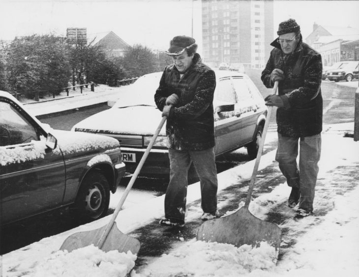 1987: Street orderlies George Douglas (left) and Ronald Walker clear the snow from the Greenfern Road, Mastrick, pavements this morning.