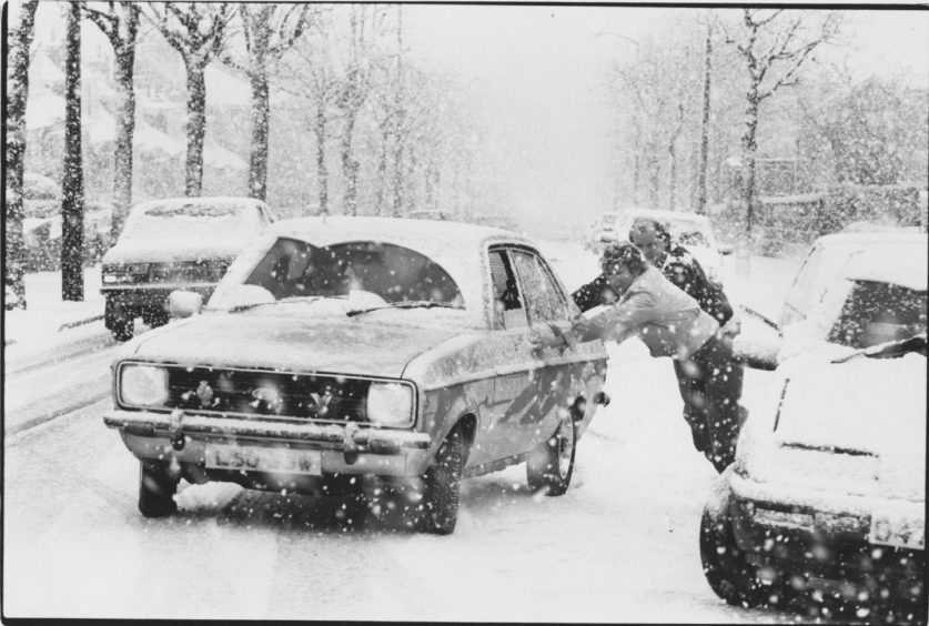 1988: Drivers who slithered to a halt going up King's Gate, Aberdeen, in the snow this morning help to push each others car out of trouble.