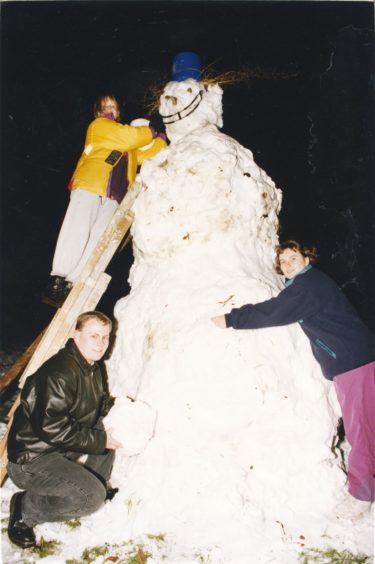 1993: Putting the finishing touches to their 10ft-tall snowman last night were these members of the Stoneywood Venture Scouts. At the top of the ladder is Angela Hutcheon, while front left is Bob Wilson and on the right is Susan Cantlay. It took them one hour to create the snowman at their Waterton Road headquarters.