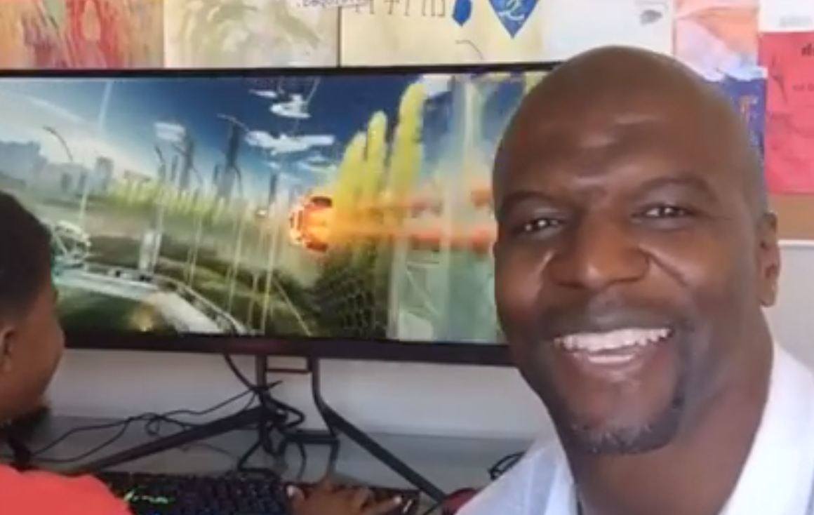 Terry Crews shows off his new pc with his son in the background.
