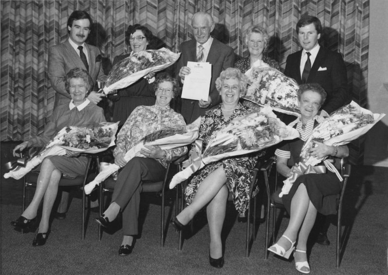 It was retiral night at the Treetops Crest Hotel when seven of the employees retired. There to present the gifts were (right, back row) general manager Gair Stott and (left, back row) deputy manager Kevin Gilling. Retiring were (back row, left to right) function waitress Mrs Peggy Shepherd (eight years), cellarman Robert Pirie (eight years) and Mrs Jean Weatherly, waitress (five years). Front (left to right) function waitress Mrs Ethel Collins (13 years), kitchen maid Mrs Elizabeth Cooper (three years), Mrs Evelyn Hamill, canteen supervisor (six years) and still room maid Mrs Betty Watt (10 years).
