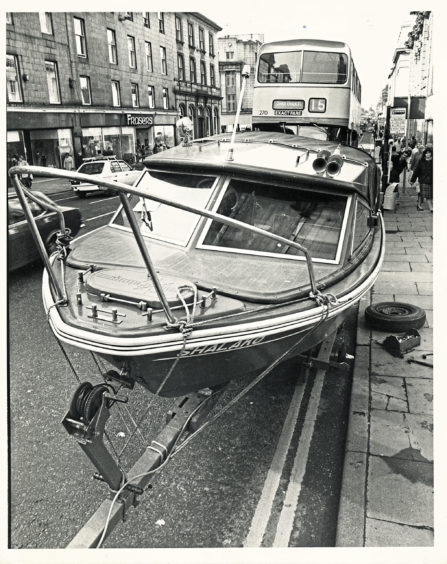 1983: Traffic wardens in Aberdeen's busy Union Street were all at sea when this 17ft boat ran aground. But as owner Ally Stephen revealed they were really quite friendly when they saw the unscheduled docking was unavoidable. For Shalako shed a wheel near the busy Market Street junction, and had to be left while Ally fetched tools to repair the stipped wheel nuts. Ally got the Shalako just over a year ago and keeps it at Stonehaven harbour. He was transporting the boat for a refit before the summer season. And with the benefit of some roadside repairs she was ready to finish her journey - after proving that not every master of a boat gets a ticket.