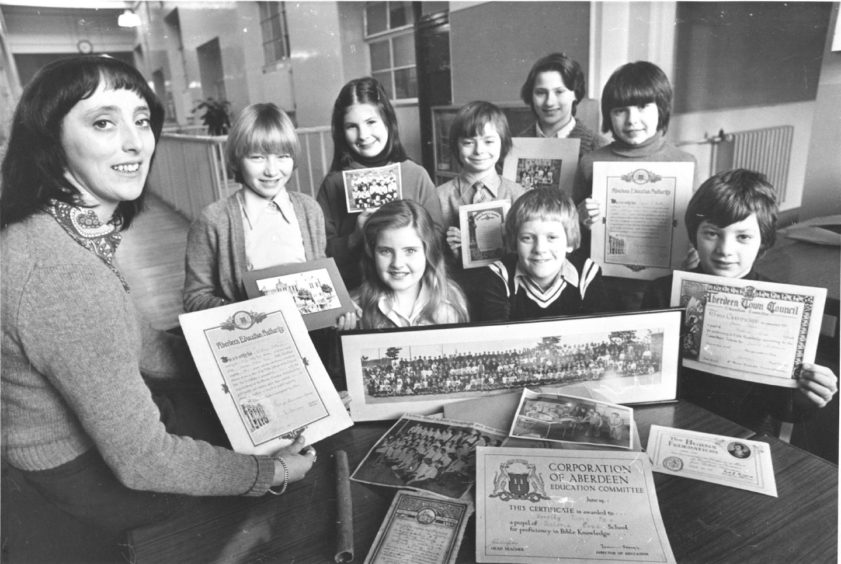 1978:  Primary 7 pupils at Victoria Road School and their teacher Mrs Mary Mitchell sort out photographs and certificates sent in by former pupils.